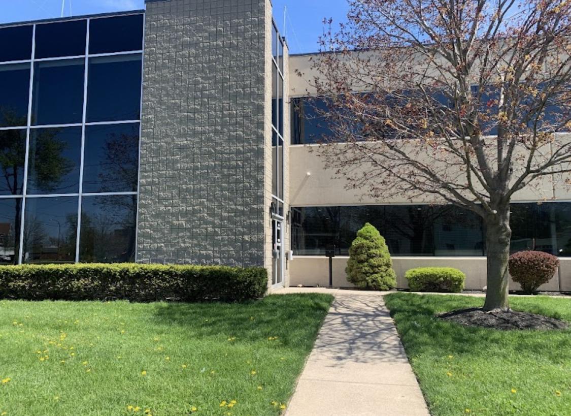 Dunkirk Clinic building fron the outside, large windows and summer trees